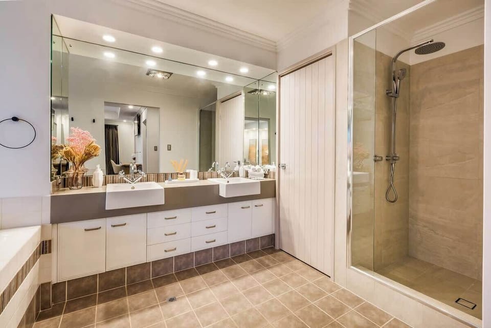 The main bathroom offers a shower and dual vanities.