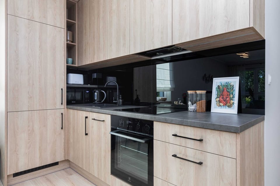 A closer look at the kitchen with its modern appliances, wooden finishes, and functional design.
