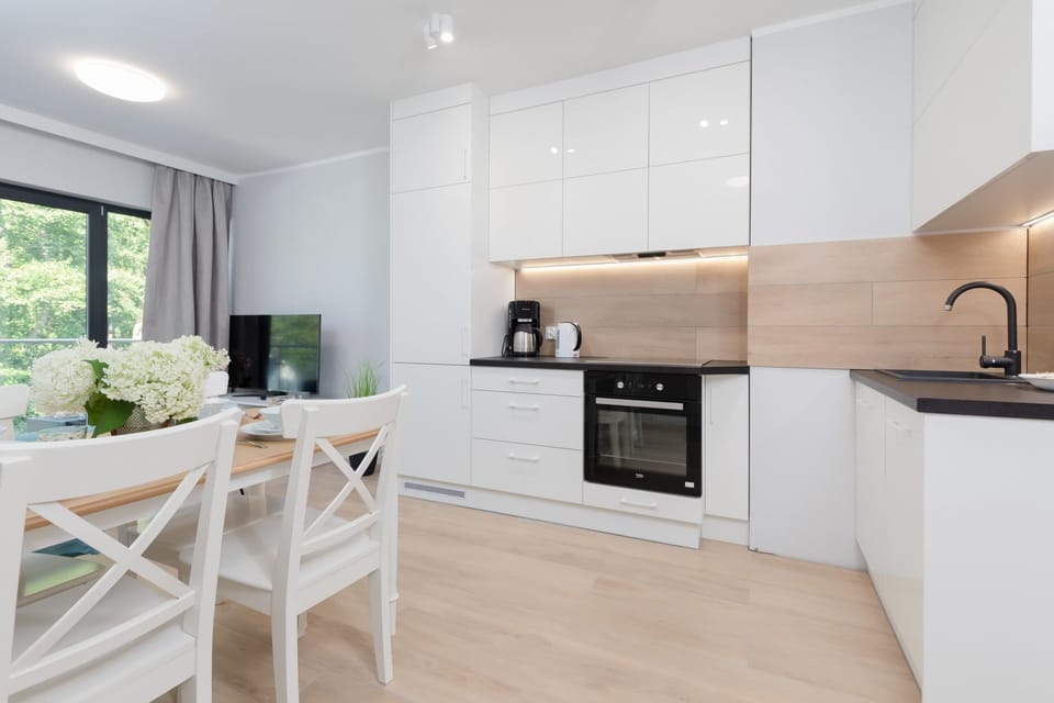 A wider perspective of the kitchen and dining area, designed with functionality and elegance.
