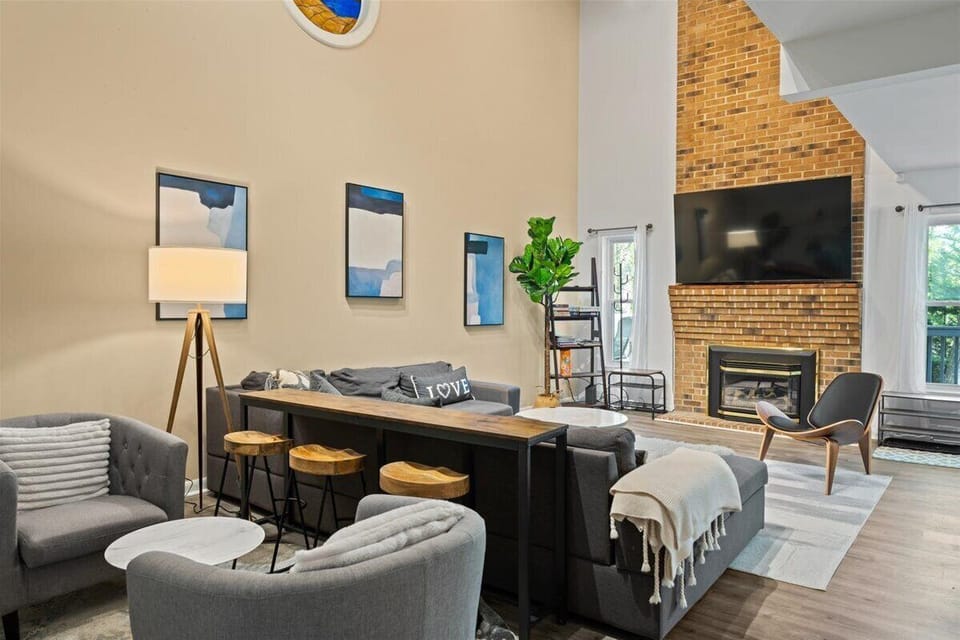 View of living area with decorative fireplace and TV