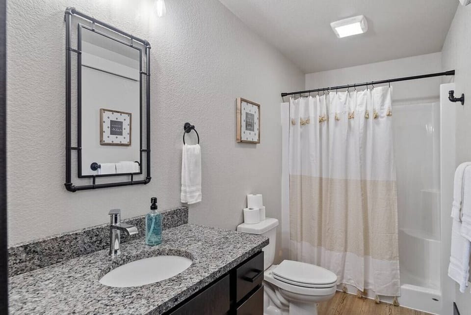 Bathroom with vanity mirror, premium towels, shower