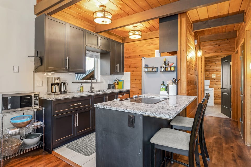 Galley kitchen with granite counter tops and stainless steel appliances