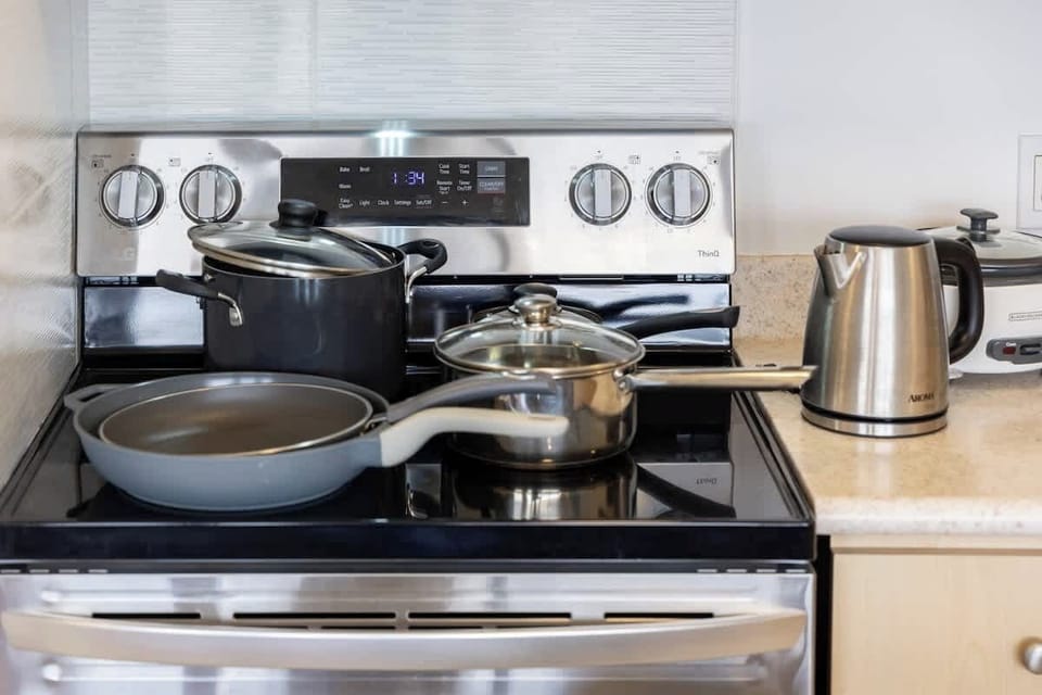 Prepare your favorite meals with ease using the full-size stove and oven provided in the kitchen.