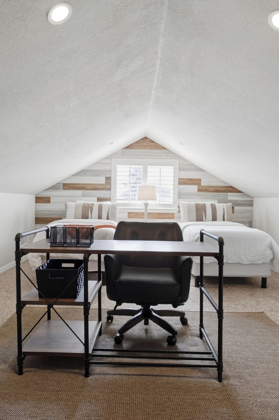 Upstairs third bedroom with two twin beds, featuring a dedicated workspace and office chair.