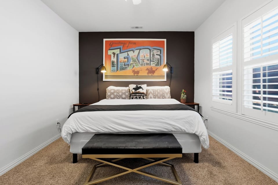 Relax in a queen-sized bed surrounded by stylish Texas-themed decor. This room offers a cool, quiet haven with full central AC and a ceiling fan for added comfort.