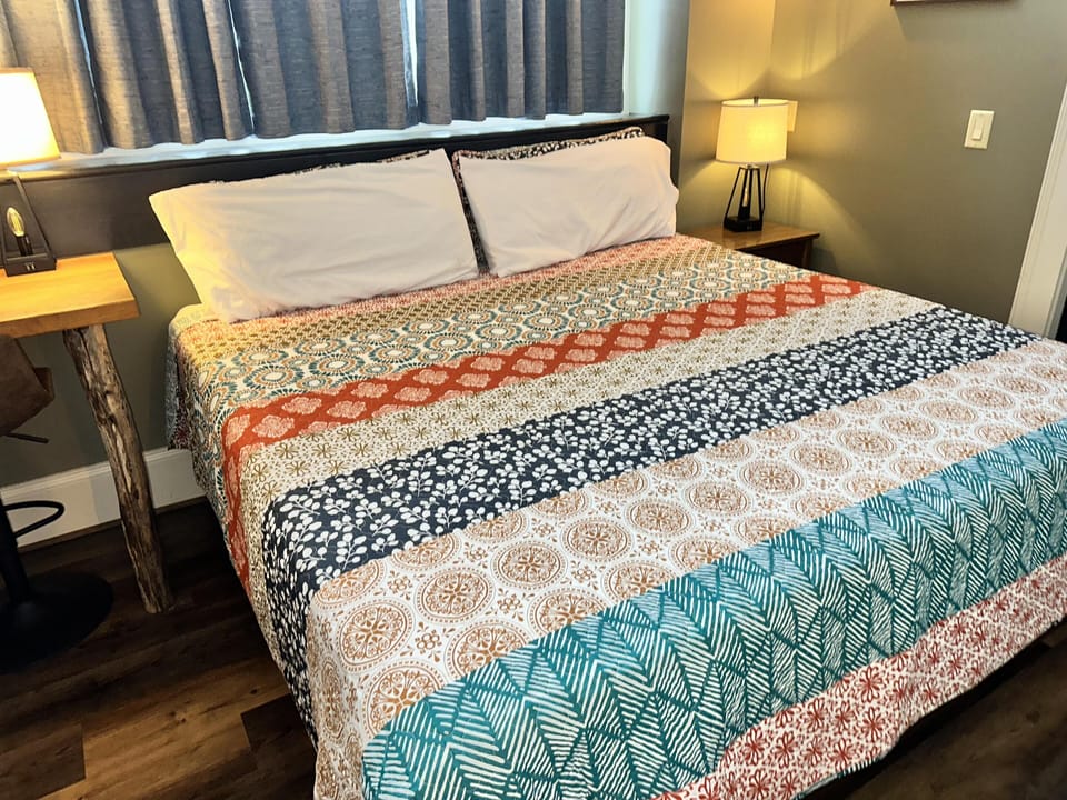 Cozy bedroom retreat with vibrant, patterned bedding and warm lighting