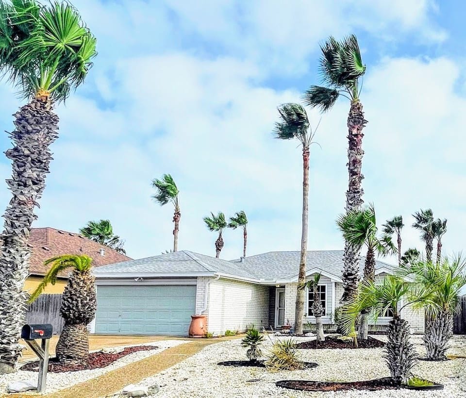 Surrounded by beautiful Palm trees. Driveway has extended parking for Boat/RV.