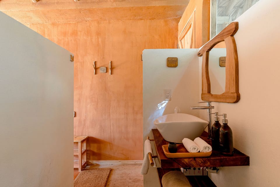 EcoLodge | Bathroom | Shower, rainfall showerhead, bathrobes, towels