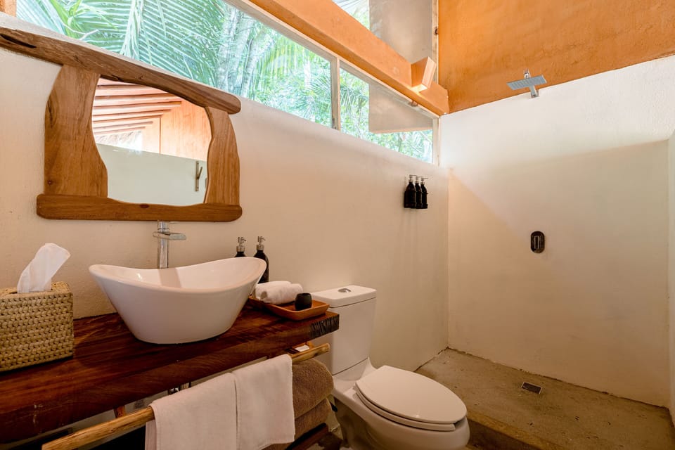 EcoLodge | Bathroom | Shower, rainfall showerhead, bathrobes, towels