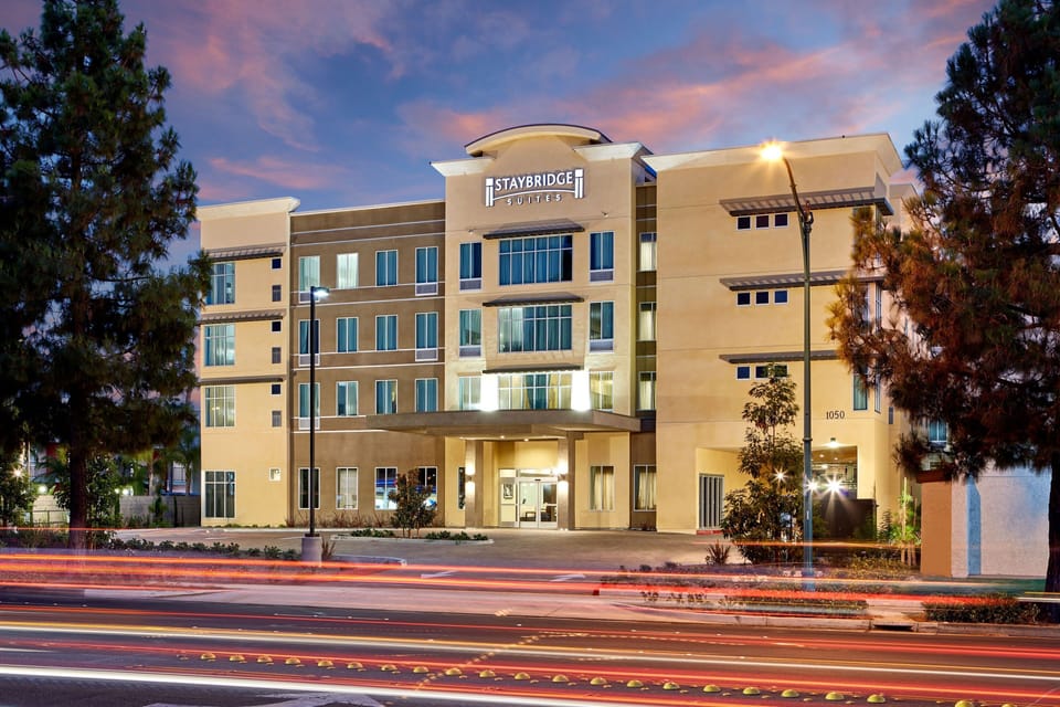 Modern multi-story building exterior with large windows and welcoming entrance.