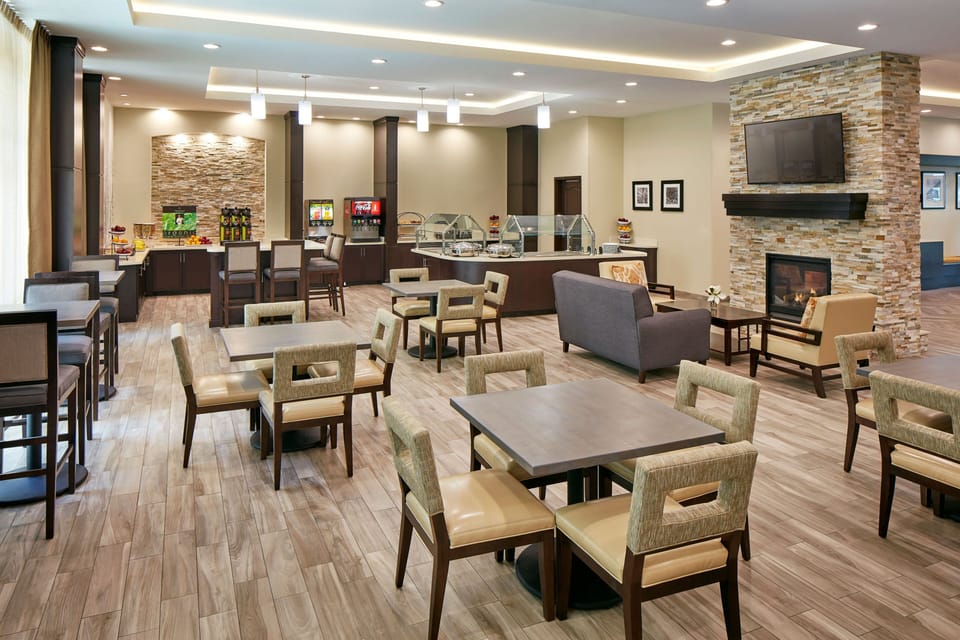 Bright dining area with modern seating for complimentary morning breakfast.