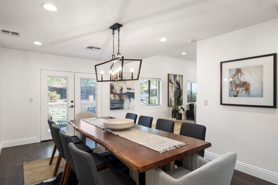 Gather in sophistication! Our spacious dining area with a 10-seater table, elegant chandelier, and striking painting offers the ideal setting for sharing meals and making memories.