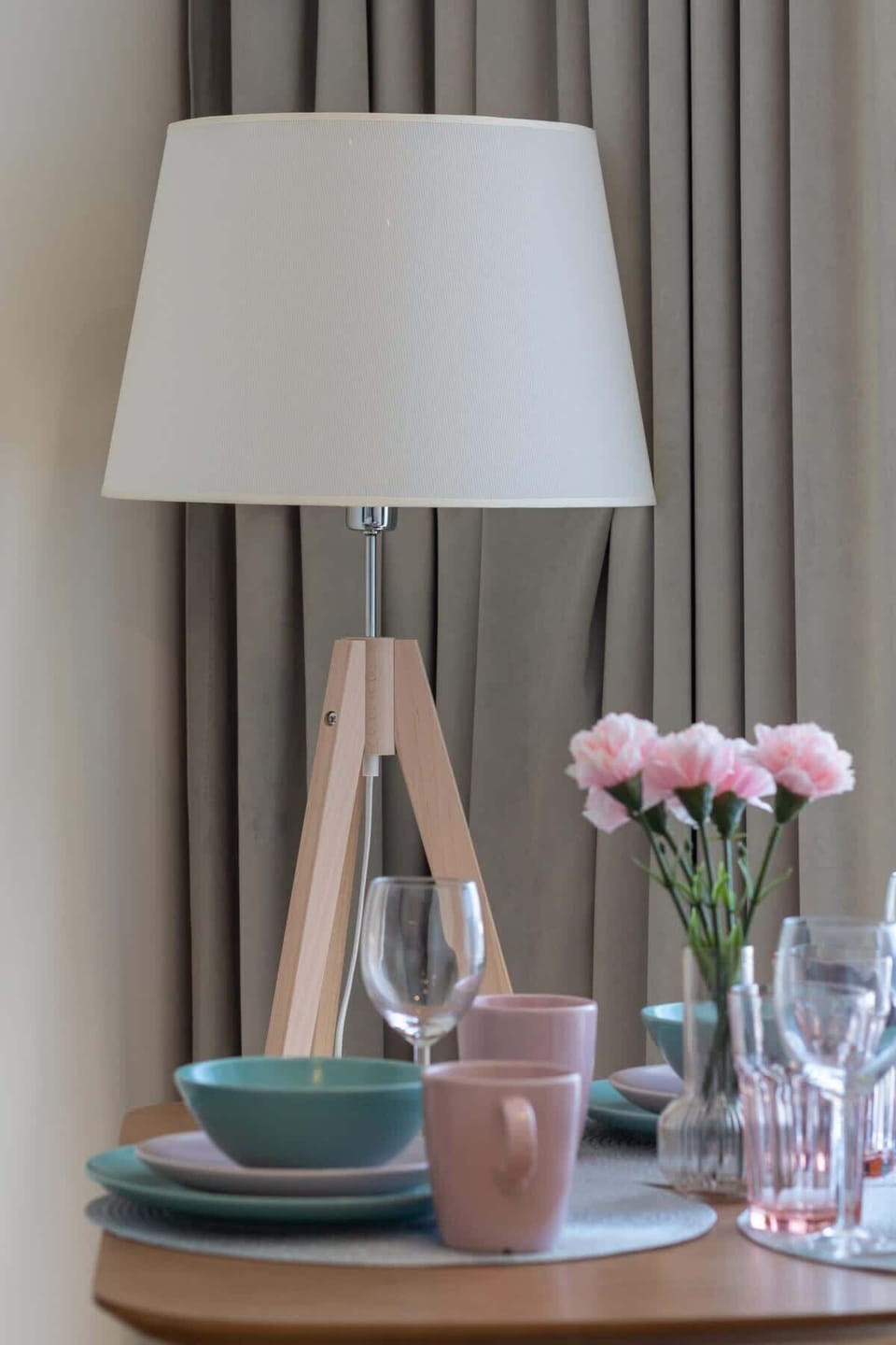 Close-up of a diesagner wooden table with elegant kitchenware.