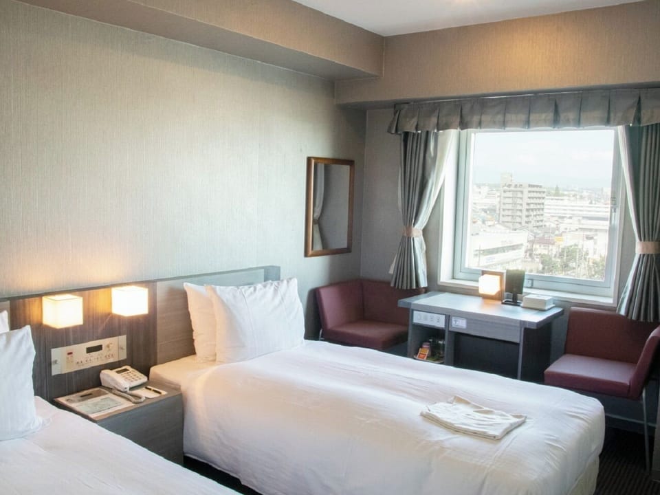 Economy Twin Room, Non Smoking | Down comforters, desk, blackout drapes, WiFi (free)