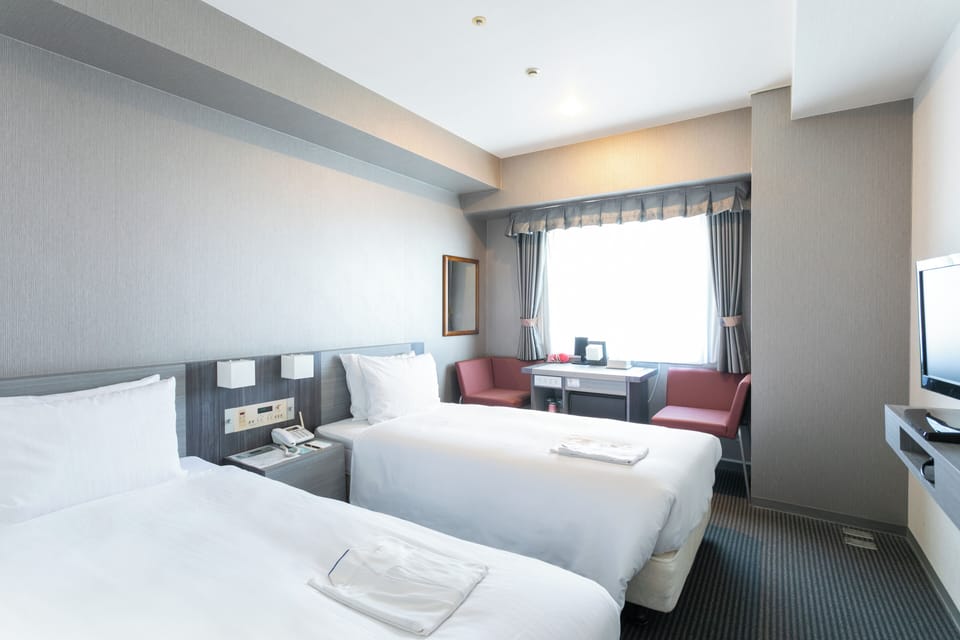 Economy Twin Room, Non Smoking | Down comforters, desk, blackout drapes, WiFi (free)