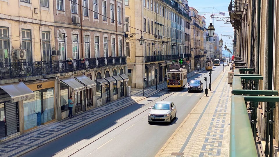 Step out onto your private balcony and immerse yourself in the vibrant energy of Lisbon, watching iconic yellow trams glide by as you soak in breathtaking historic city views. Enjoy your morning coffee with a lively street scene as your backdrop, offering