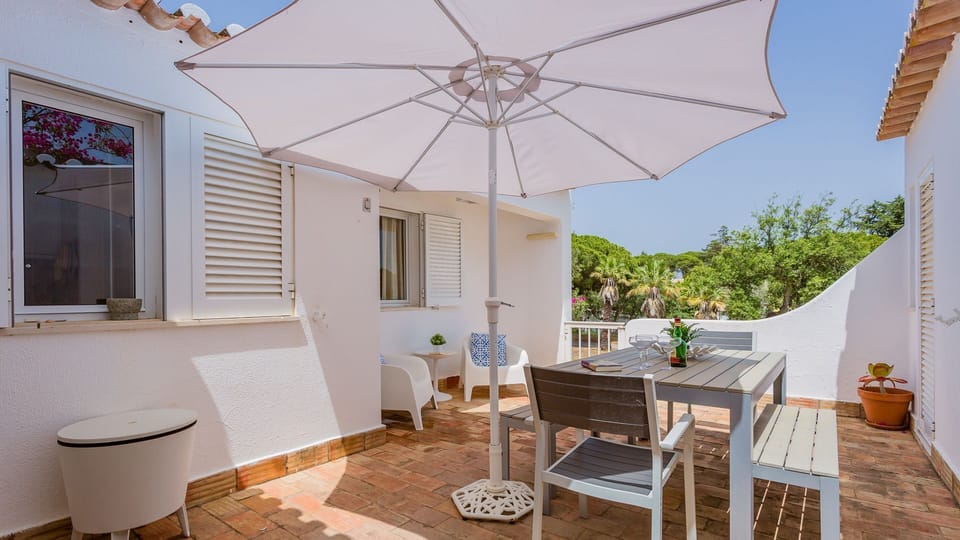 Relax with a cool drink on the spacious terrace, offering refreshing breezes and glimpses of distant trees.
#Terrace #OutdoorSeating #LovelyStay