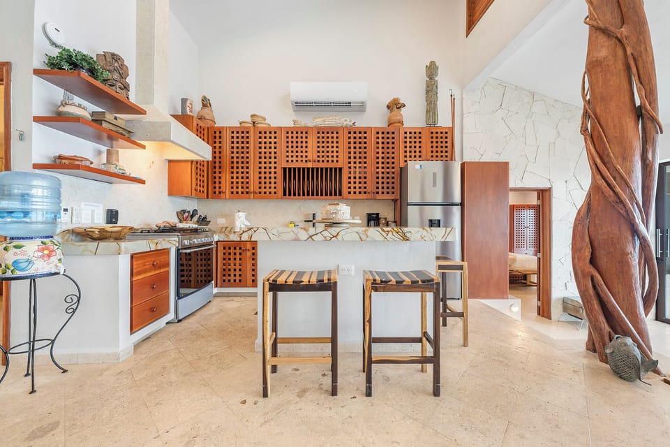 Well stocked modern kitchen connected to the living area and dinning area.