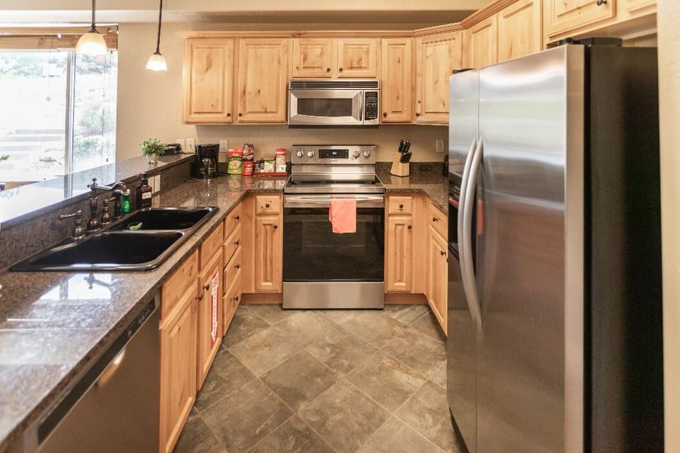 Fully equipped kitchen with sleek stone countertops and stainless appliances.