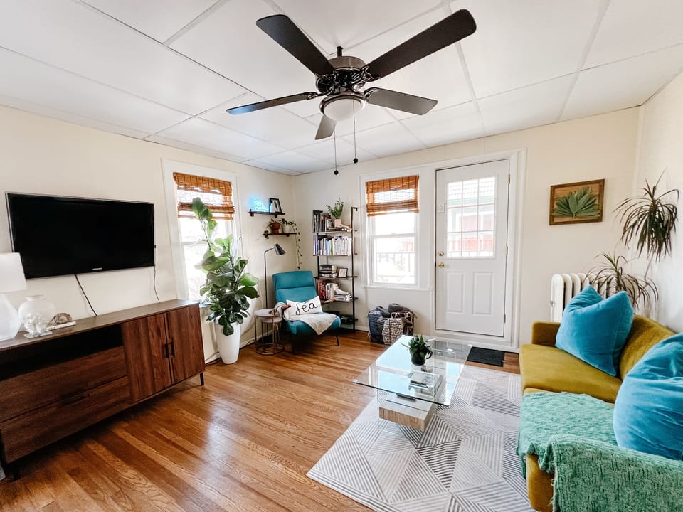 Living room with futon couch. Full sized & toddler air mattress