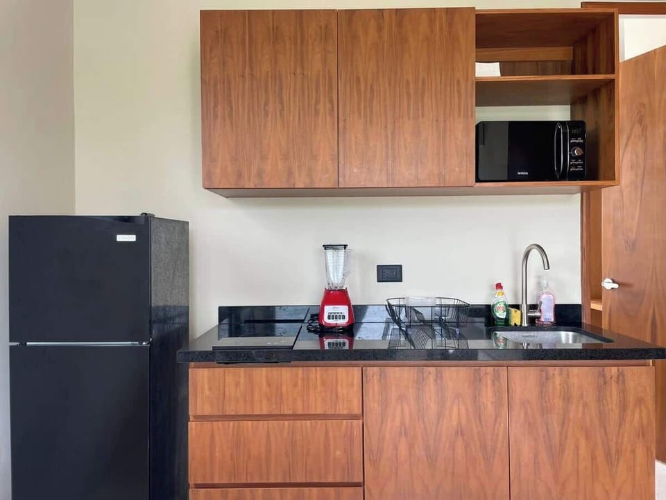 Fully equipped kitchen with refrigerator and stove