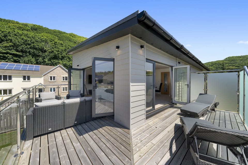 The Cube, Portreath. Balcony: Marvellous wrap-around balcony furnished with sun loungers and a rattan sofa with matching chairs