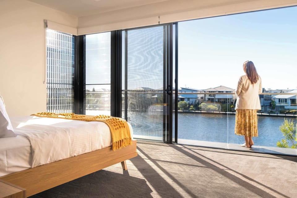 The master bedroom features a queen sized bed and gorgeous waterfront views.