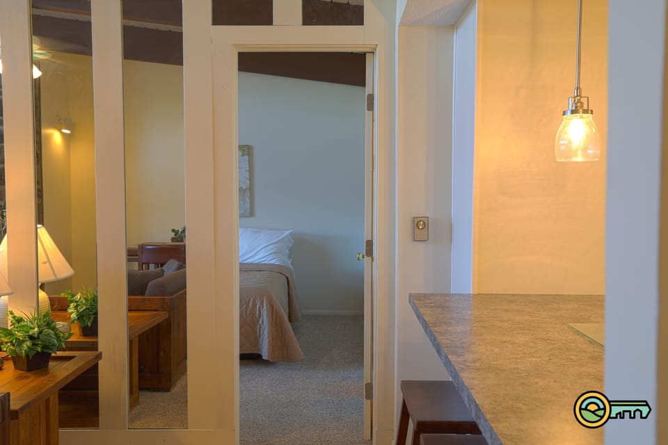 Living room, kitchen view into bedroom