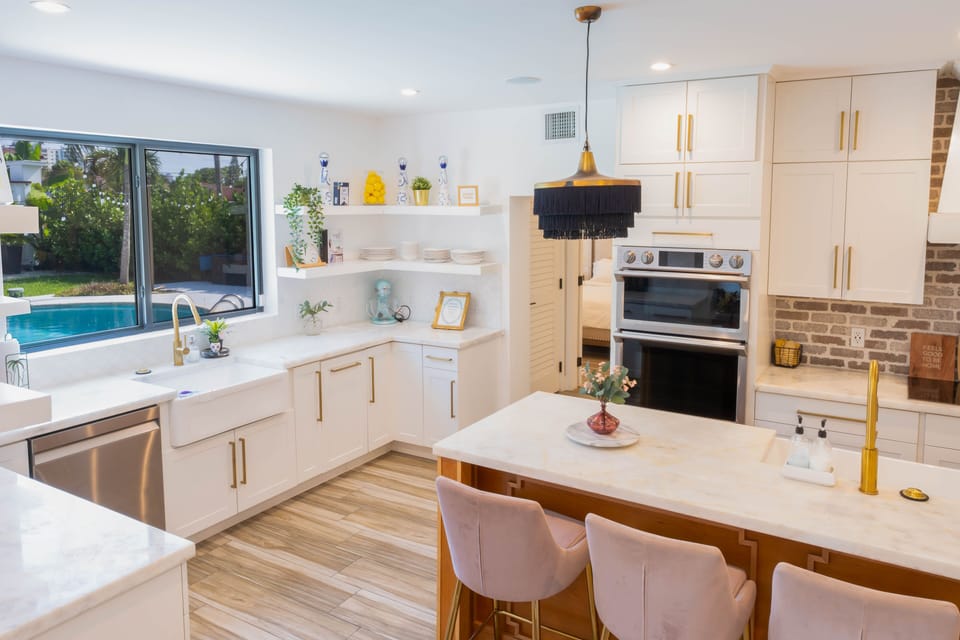 Experience the kitchen and island with a view of the pool