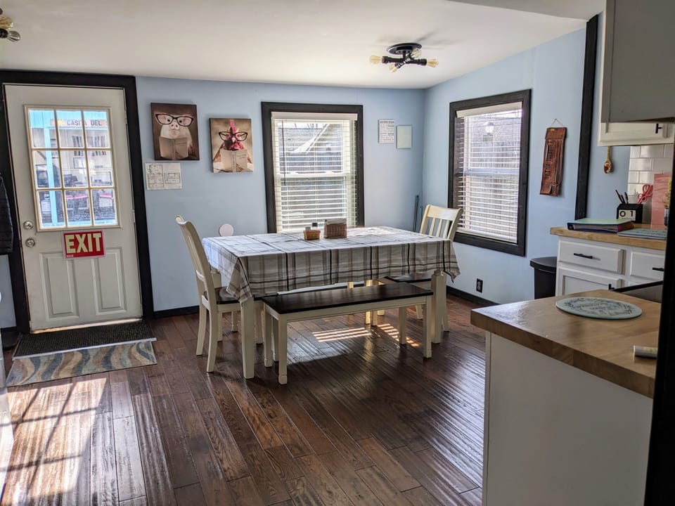 Dining for up to 8 with view of gazebo and fenced in yard.