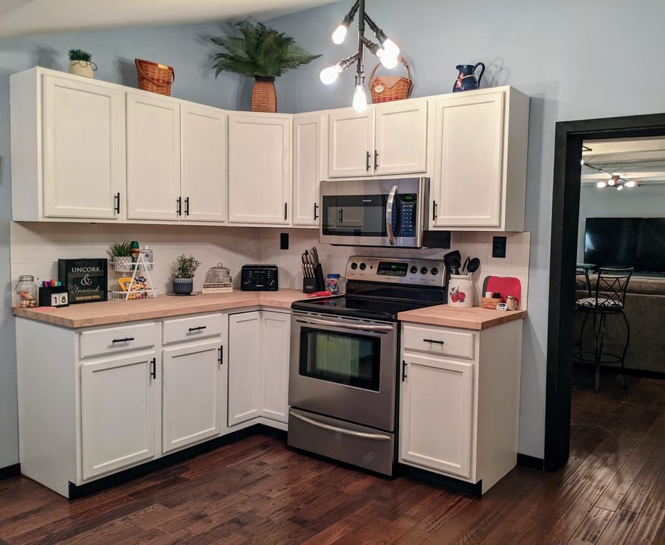 Full-size appliances and all necessities to cook a full meal in the cabinets. 