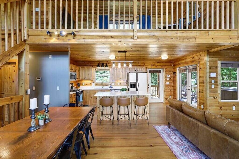 Open concept living, dining room and kitchen leading out to the large porch