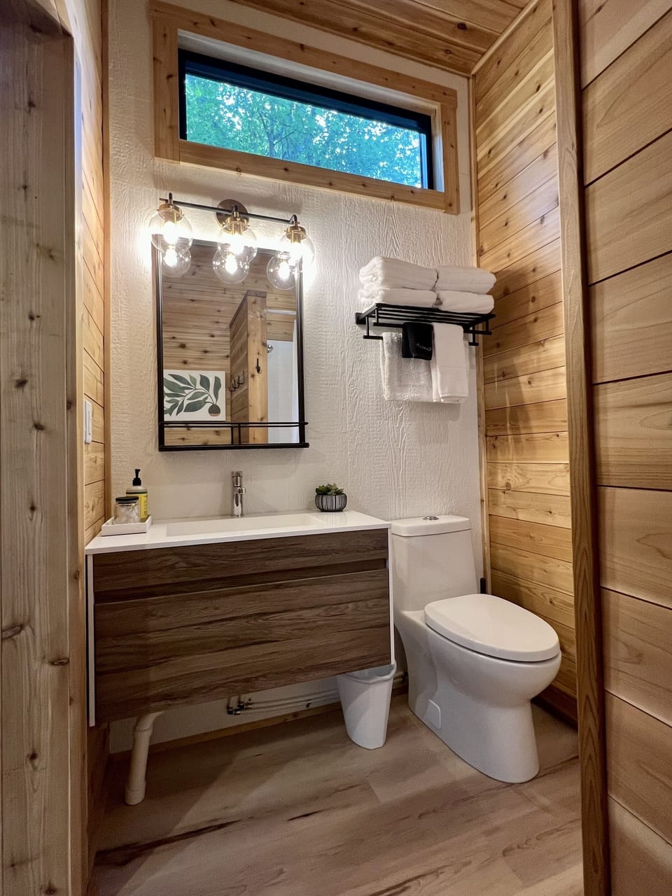 The spacious bathroom has high ceilings and lots of natural light.