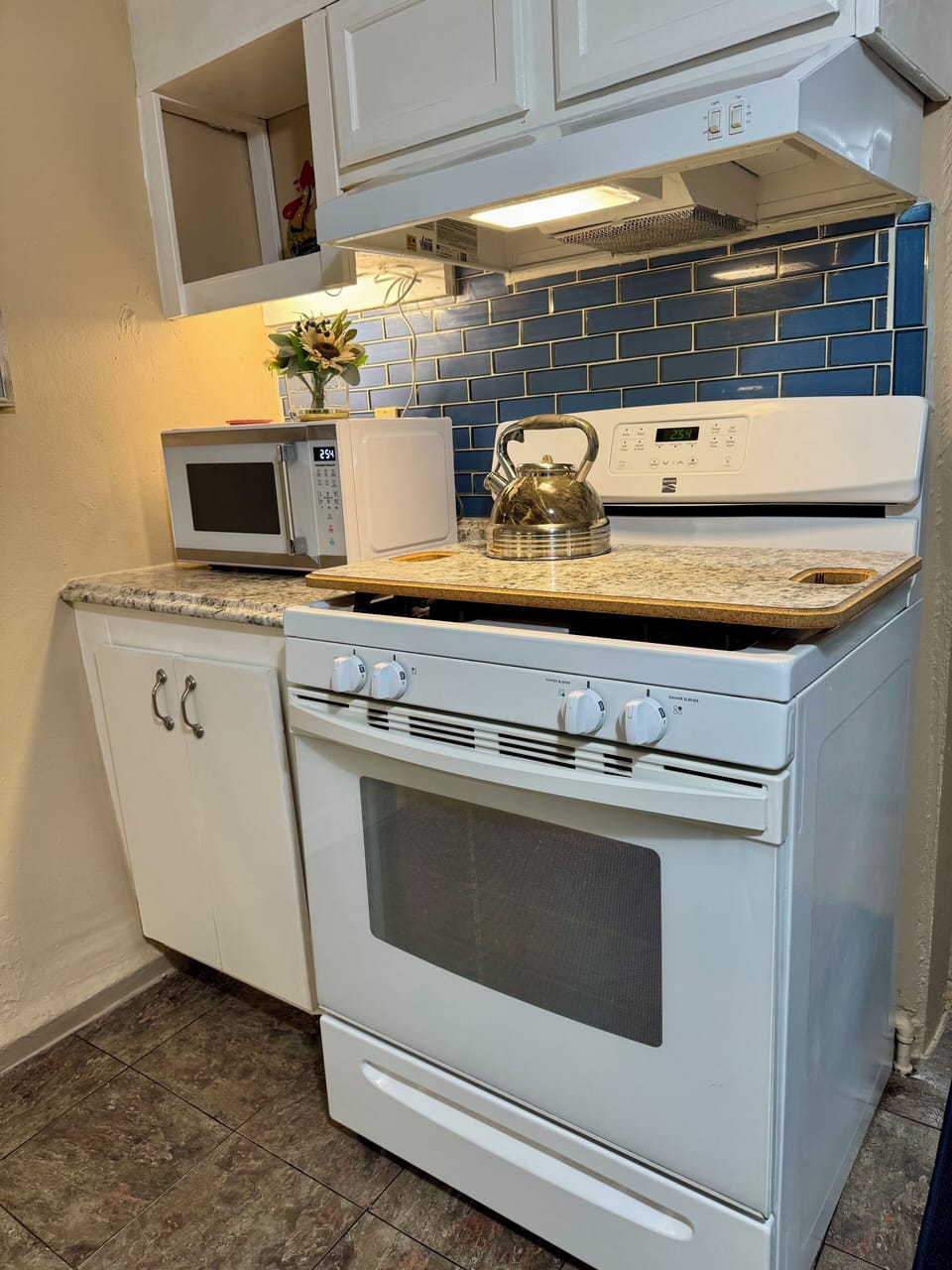 Gas Stove and photo of microwave.