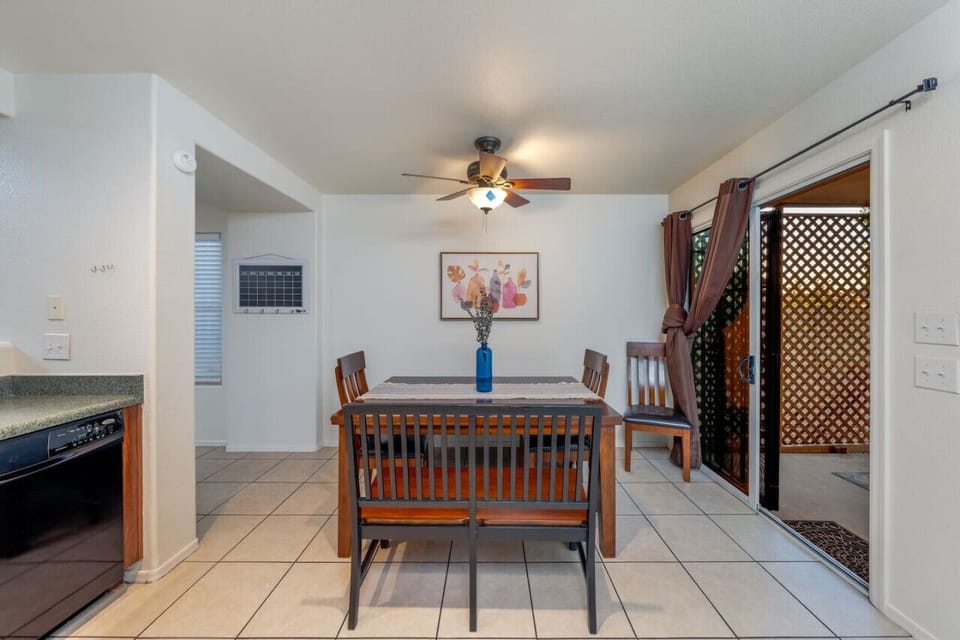Dining table with view of backyard`s covered patio