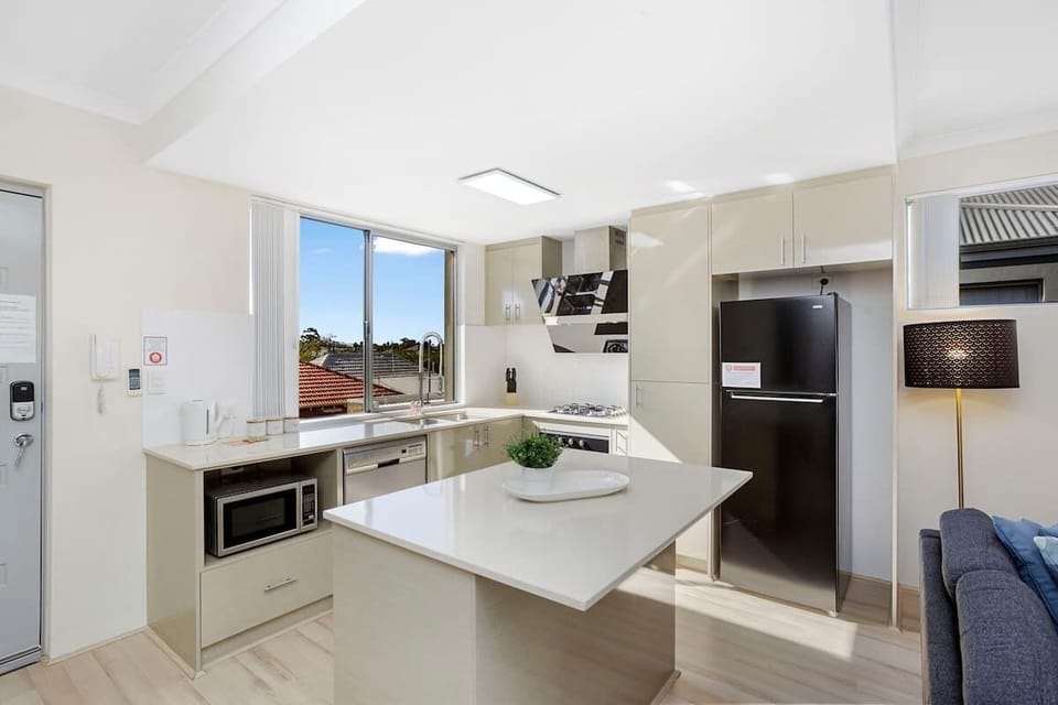 Prepare meals with ease in this well-appointed kitchen. Featuring a fridge for your groceries, a microwave for quick bites, a dishwasher for convenience, and a dedicated coffee section to kickstart your mornings.