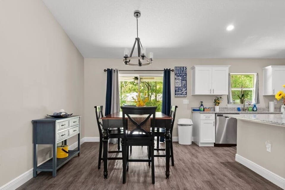 Dine in the well-lit dining area with a view of the yard.
