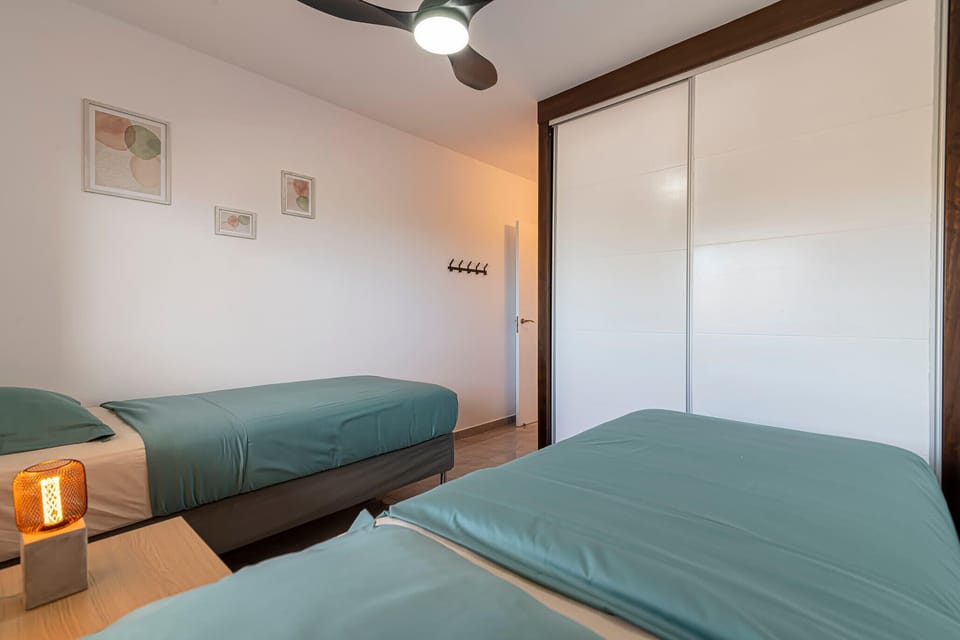 A bedroom with planks to store clothes.