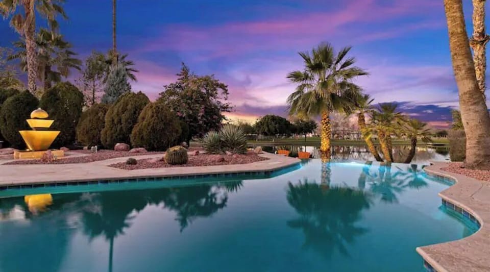 Infinity Edge Heated Pool Facing the Lake and Park alongside Lighted Fountain