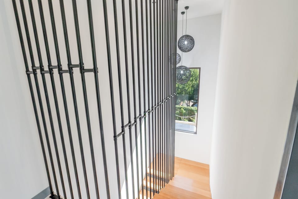 Stairs leading from the 2nd floor from the bedrooms to the living area