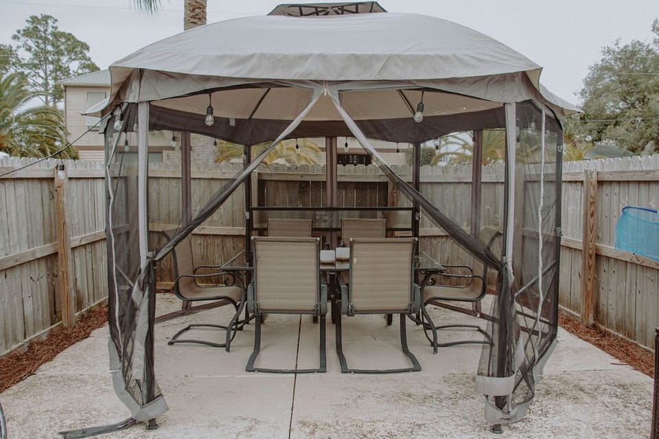 Outdoor canopy and dining table for 6. Plug in the string lights for added light