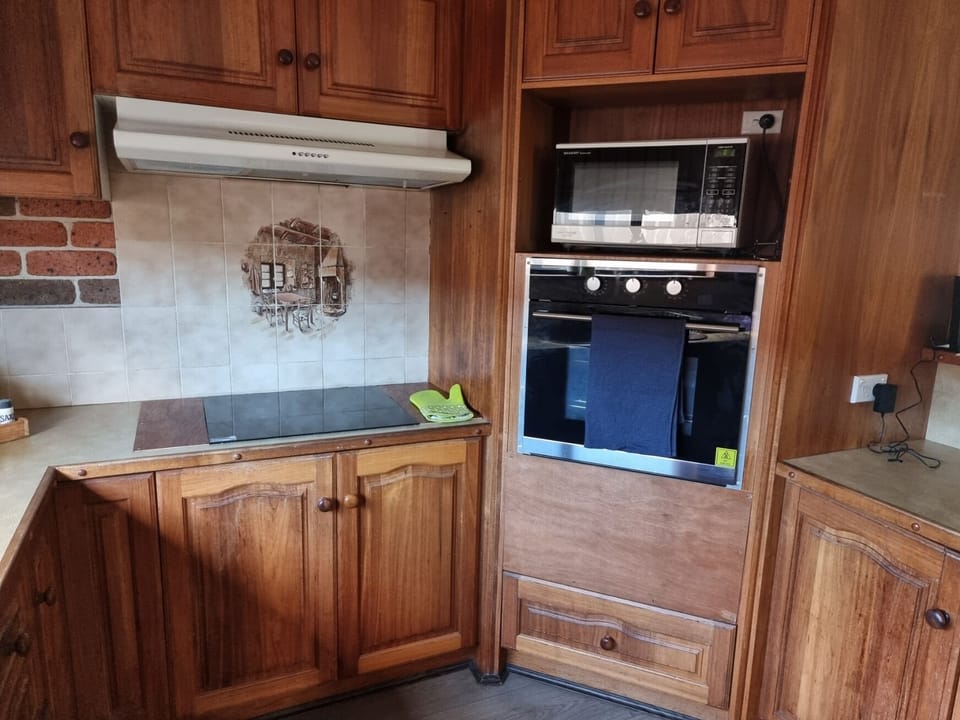 Country Style kitchen with Wall Stove, oven, dishwasher, microwave and utensils