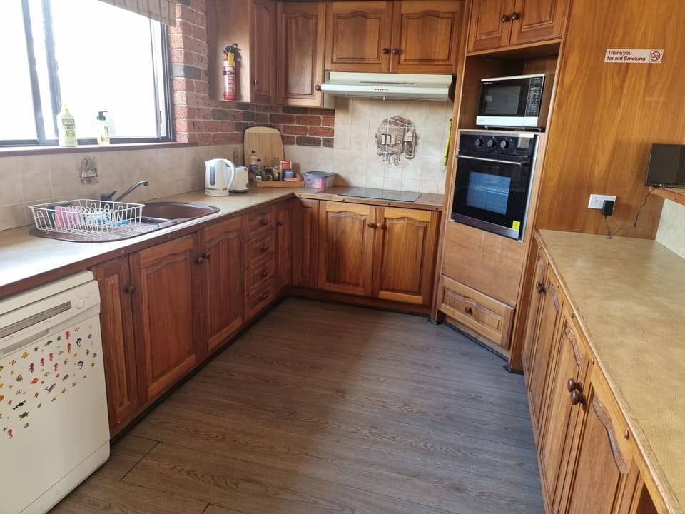 Country Style kitchen, dishwasher, microwave, wall oven and cook top.
