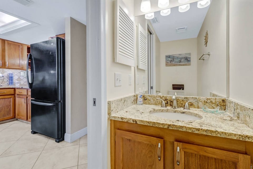 A half bath is conveniently located off the entry hallway, across from the kitchen.