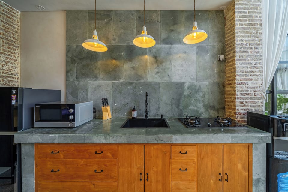 Design Villa, 1 Bedroom | Private kitchen | Full-size fridge, stovetop, cookware/dishes/utensils, dining table