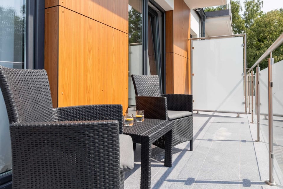 The furnished balcony offers a perfect spot for morning coffee with a view.