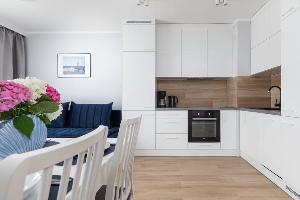 The sleek design of the kitchenette blending seamlessly with the living area.