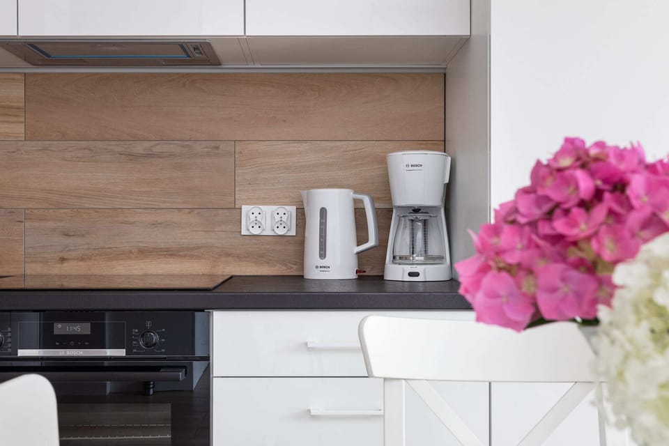 The sleek design of the kitchenette blending seamlessly with the living area.