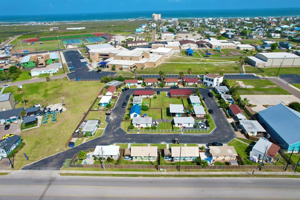 Aerial view of coastal community with nearby beach access and local amenities.