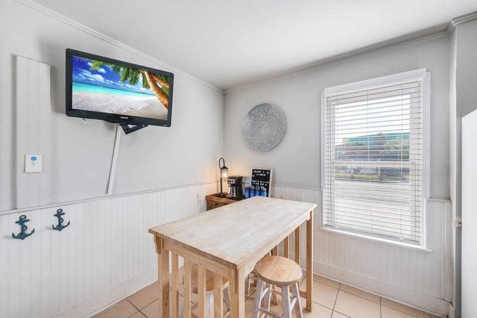 Enjoy your morning coffee at this cozy dining nook, complete with wall-mounted TV for entertainment while you plan your day's adventures.